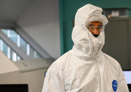 A semiconductor student wearing a clean room bunny suit