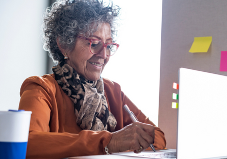 An image of a mature woman using a laptop.