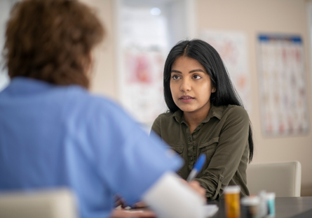 Image of a woman talking to a healthcare professional