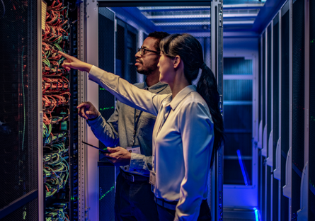 Image of two people in a computer server room