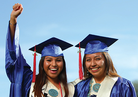 Image of two Native American students at college graduation