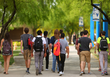 Image of a group of college students walking across a campus