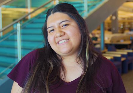 An image of a smiling female HSI EXCELlence student wearing a maroon shirt 