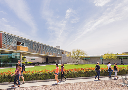 Image of students walking on a college campus 