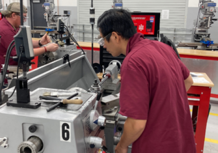 Image of two students working in the GWCC Machining Lab