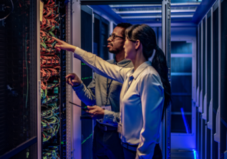 Image of two people in a computer server room